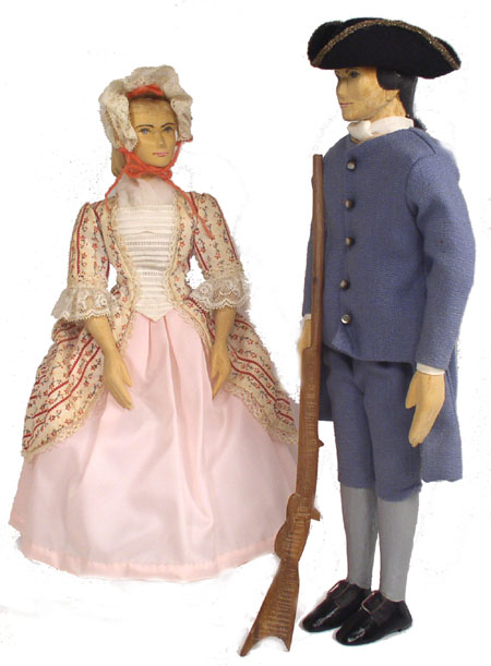 Front view of husband and wife wooden dolls dressed in period costumes of America in 1775