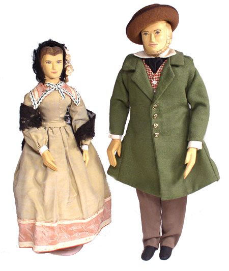 Front view of husband and wife wooden dolls dressed in period costumes of America in 1840