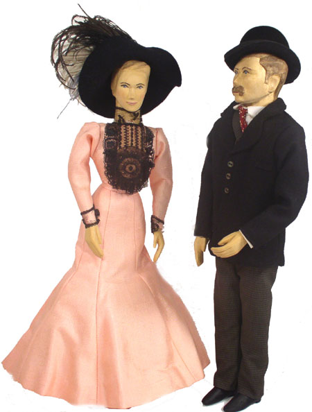Front view of husband and wife wooden dolls dressed in period costumes of America in 1900