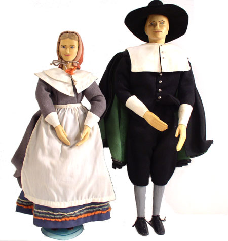 Front view of husband and wife wooden dolls dressed in period costumes of America in 1630