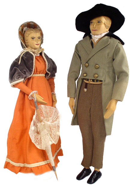 Front view of husband and wife wooden dolls dressed in period costumes of America in 1811