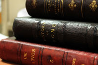 Stack of repaired leather bound books.
