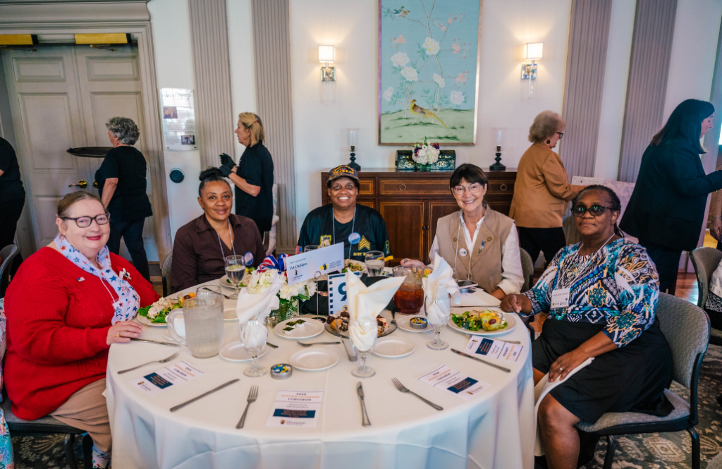 women veterans seated at a table, enjoying lunch