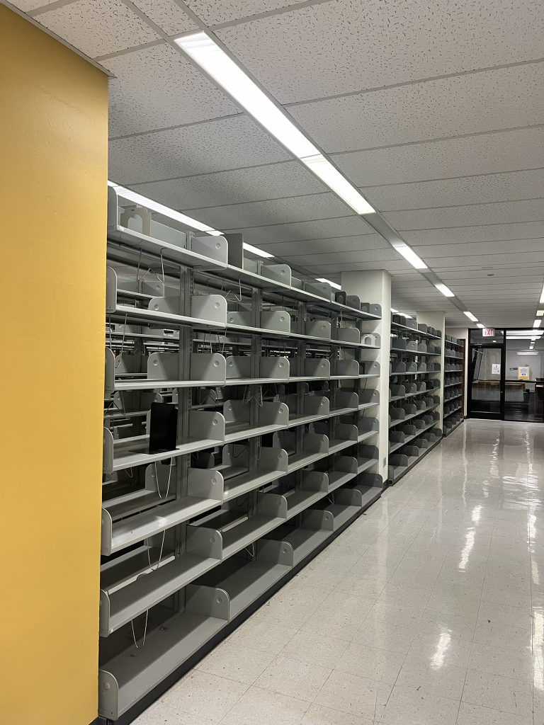 Empty bookshelves next to a yellow column.